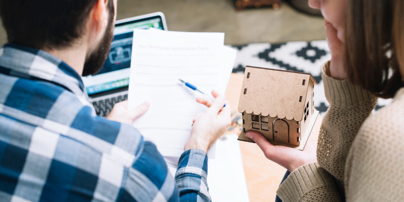 from-couple-with-mortgage-agreement Homebuyers comparing their mortgage rate quotes with a lender