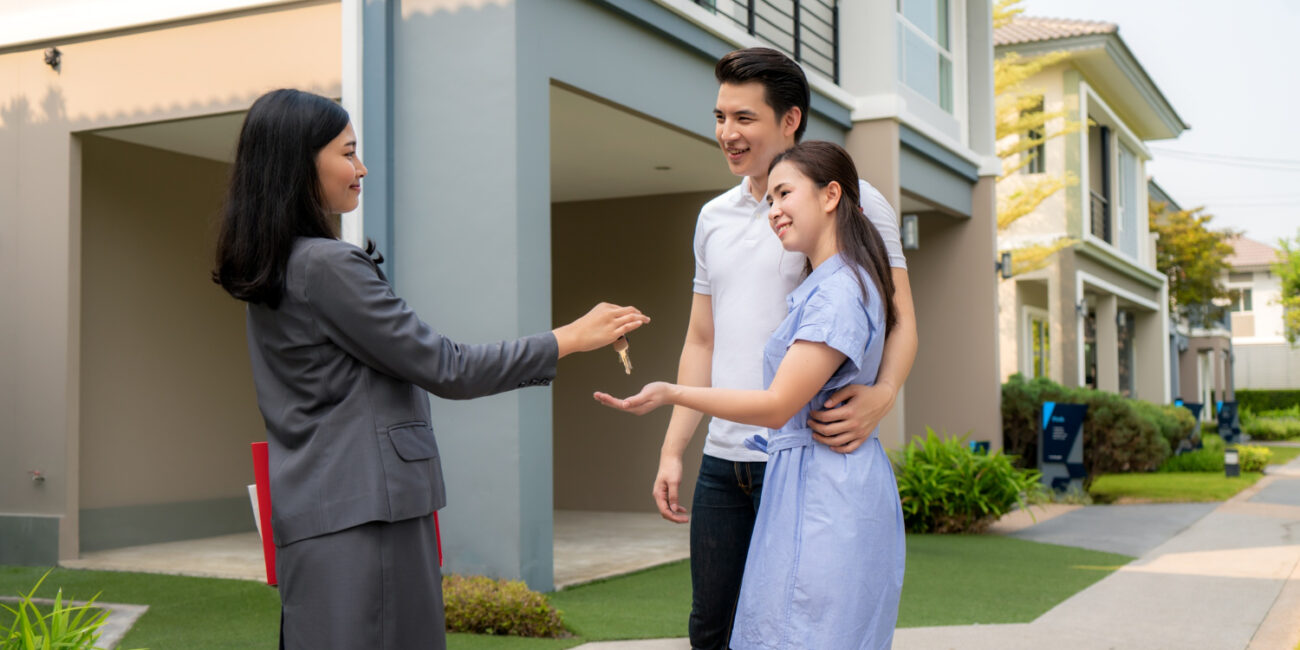happy-smile-young-couple-take-keys-new-big-house-from-real-estate-agent Co-buying a home in California with friends or family