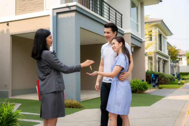 happy-smile-young-couple-take-keys-new-big-house-from-real-estate-agent Co-buying a home in California with friends or family