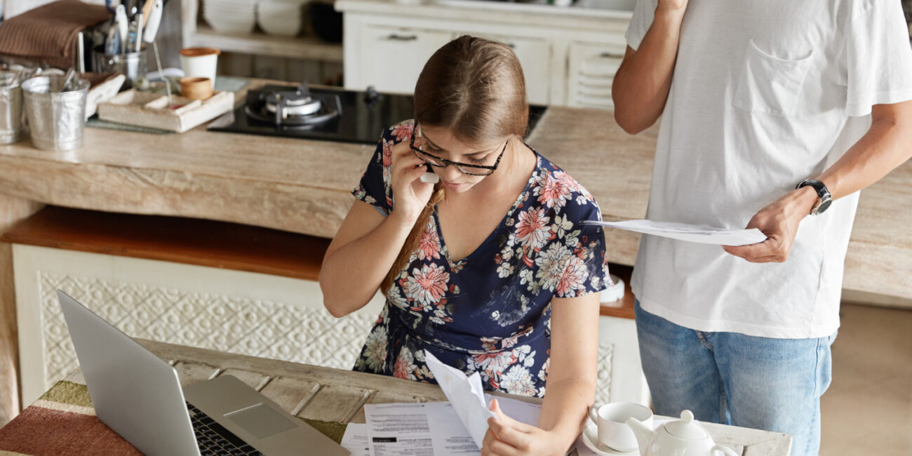 couple-managing-budget-together-kitchen Hidden costs of homeownership in California including HOA fees, taxes, and utilities