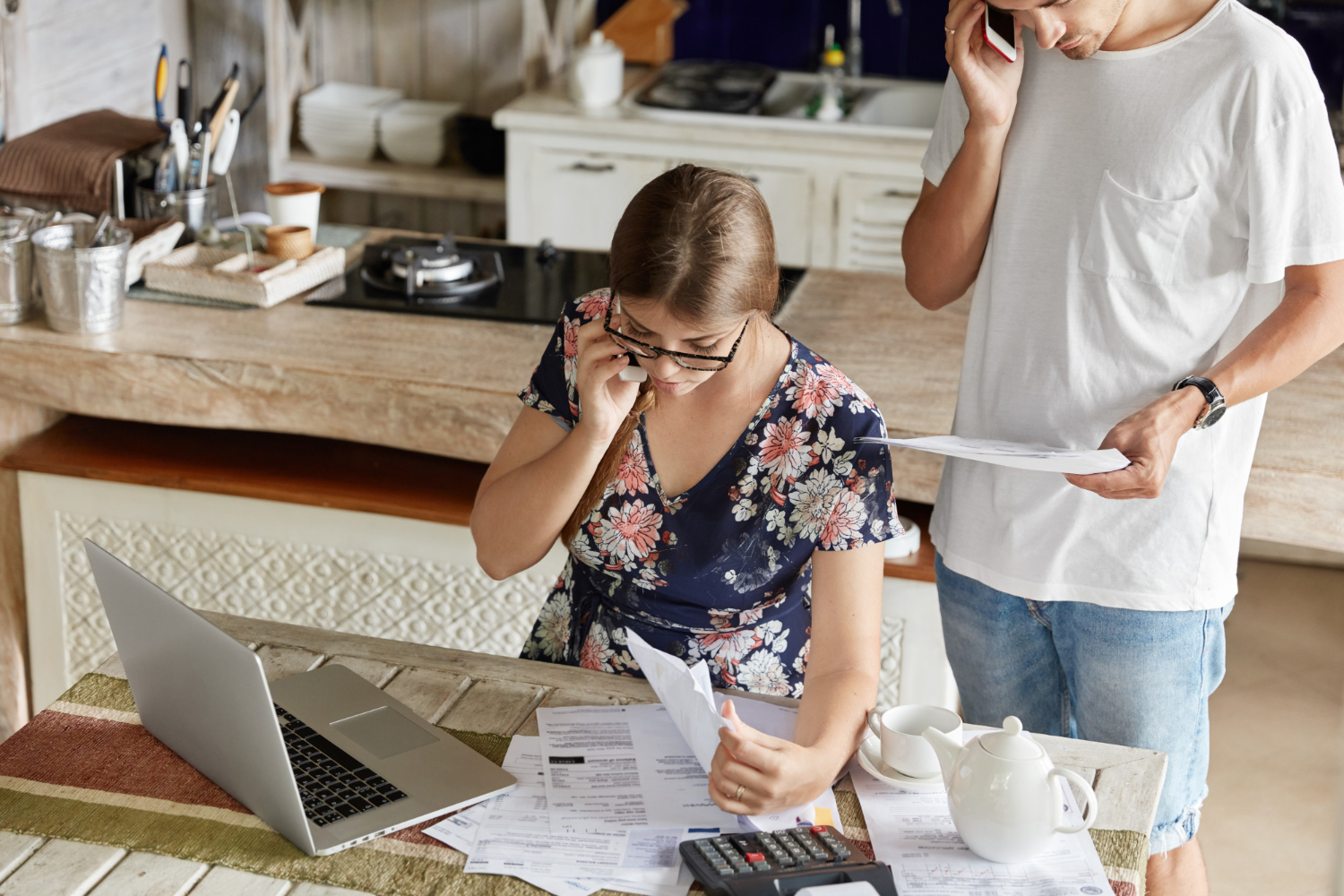 couple-managing-budget-together-kitchen Hidden costs of homeownership in California including HOA fees, taxes, and utilities