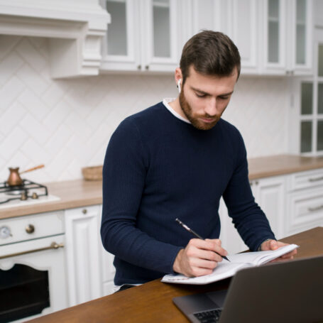 California mortgage refinancing documents reviewed by homeowner at kitchen table