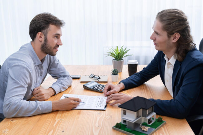 : California home buying discussion with a buyer reviewing mortgage options