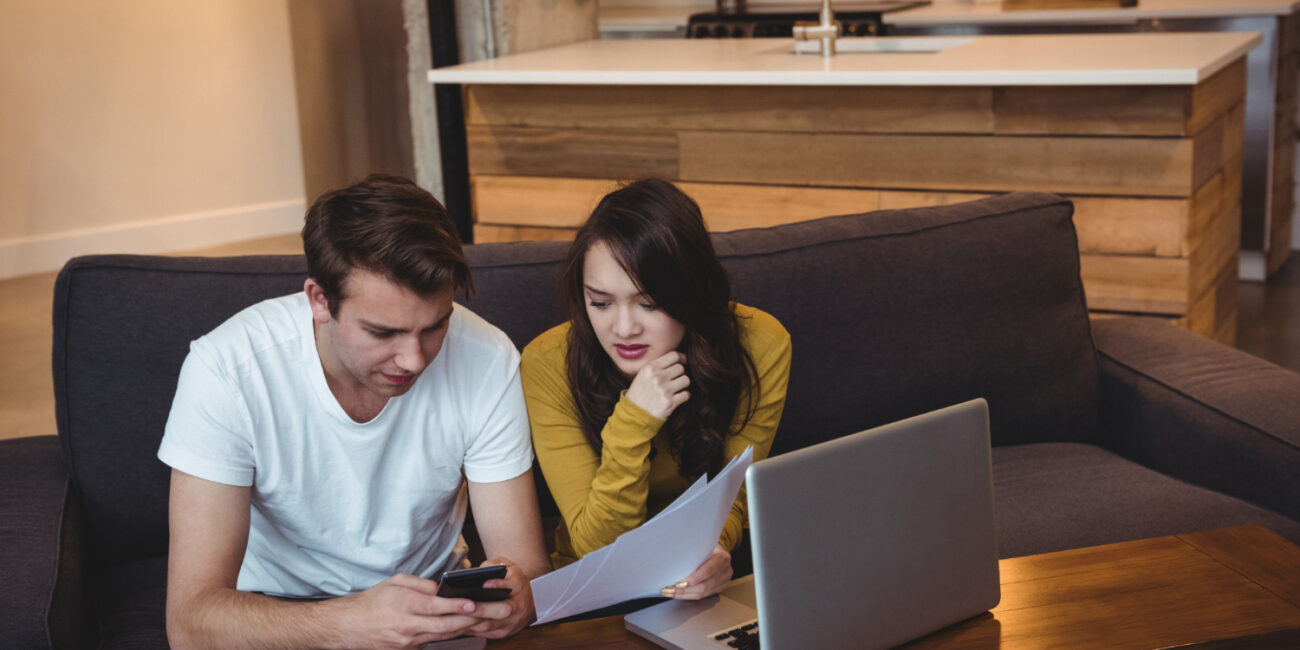 image-homeownership-costs-beyond-mortgage-payment First-time buyers reviewing homeownership costs beyond the mortgage payment