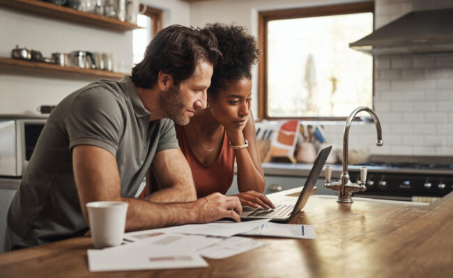 image-waiting-to-buy-home-california California homebuyer reviewing waiting to buy costs and mortgage options