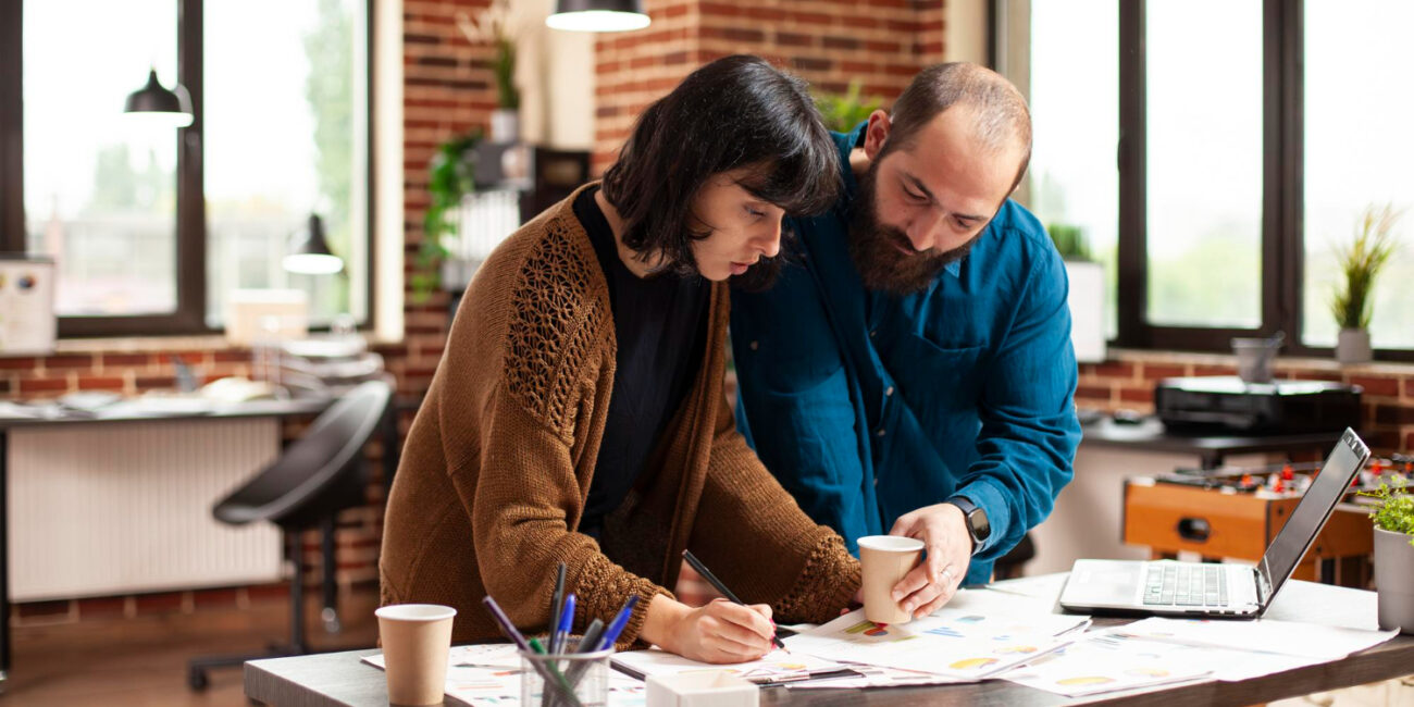 Professionals reviewing homebuying timeline from saving strategy and planning documents
