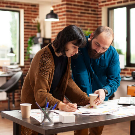 Professionals reviewing homebuying timeline from saving strategy and planning documents