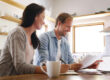 Homebuyers comparing Closing Disclosure forms with a Loan Estimate