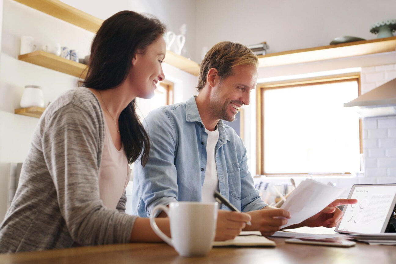 Homebuyers comparing Closing Disclosure forms with a Loan Estimate