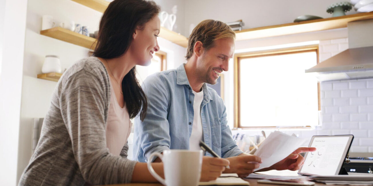 Homebuyers comparing Closing Disclosure forms with a Loan Estimate