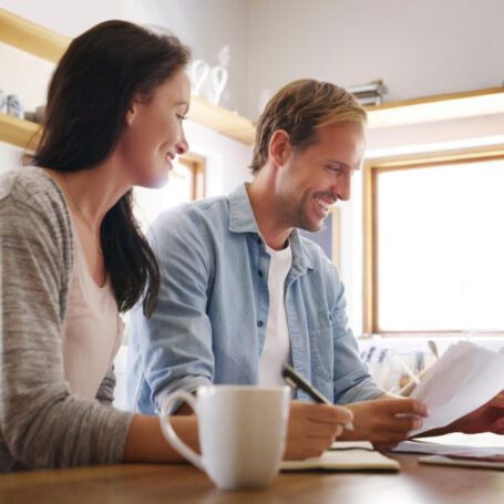 Homebuyers comparing Closing Disclosure forms with a Loan Estimate