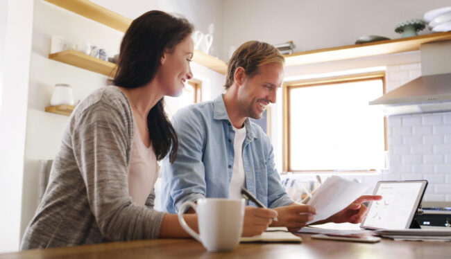Homebuyers comparing Closing Disclosure forms with a Loan Estimate